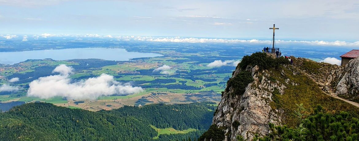 Blick vom Hochfelln auf den Chiemsee und das Gipfelkreuz